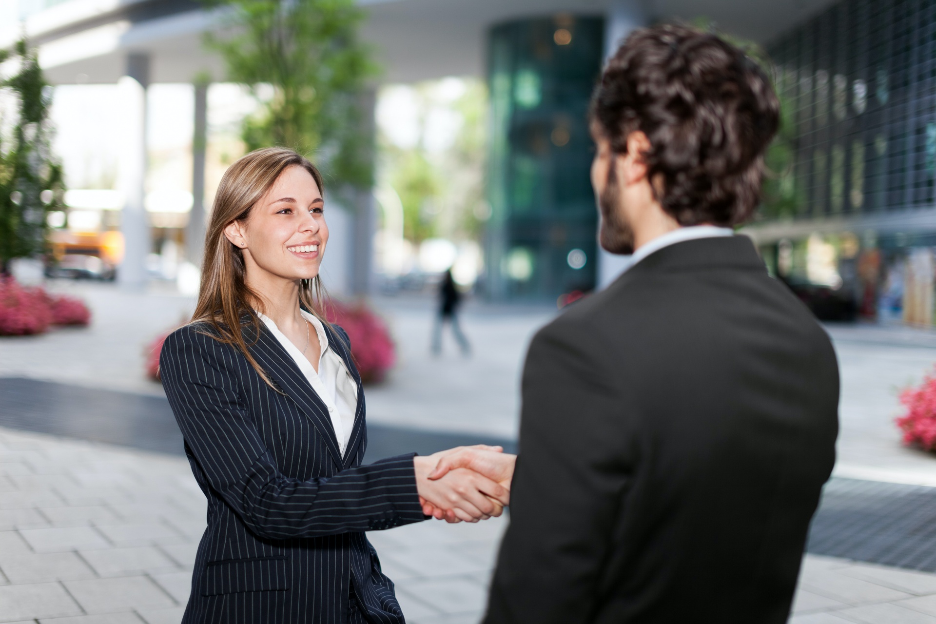 Businesswoman shaking a businessman's hand